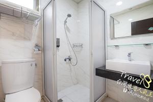 a bathroom with a shower and a toilet and a sink at Secret Garden Homestay in Ji'an