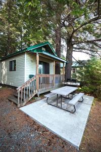 a house with a picnic table in front of it at Cabin 2 Lynn View Lodge in Haines