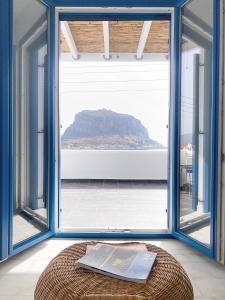 a room with a large window with a view of a mountain at LULU - Self Catering Accommodation in Monemvasia