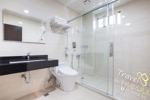 a bathroom with a toilet and a glass shower at Secret Garden Homestay in Ji'an