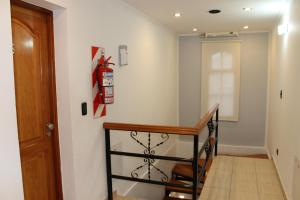 a hallway with a staircase with a wooden table at Apart Hotel Cabo San Diego in Ushuaia