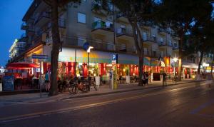 a building on a city street at night at Hotel Amalfi in Lido di Jesolo