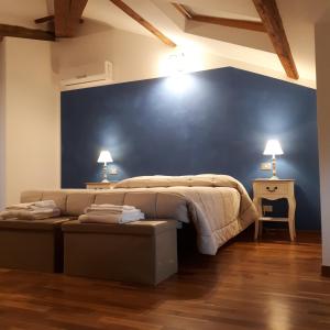 a bedroom with a bed and a blue wall at Alloggio Cantalupo in Formigine