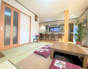a living room with a table and a kitchen at LINK HOUSE in Fujiyoshida