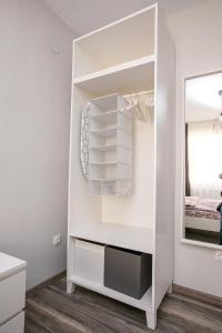 a white walk in closet with a mirror at Aparthouse Heaven in Sandanski