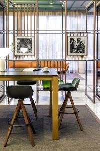 a dining room with a table and two chairs at Meliá Milano in Milan