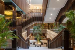 a view of a lobby with stairs and plants at Meliá Milano in Milan