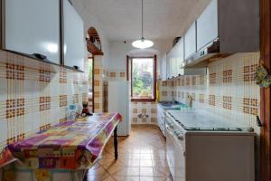 a kitchen with a sink and a counter top at Casa Elena - Porto Alabe in Tresnuraghes +27 photos