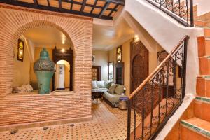 a hallway of a house with a staircase and a vase at Riad Dada Mouss & Suites in Marrakesh