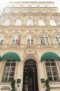 a large building with green awnings in front of it at The Bank Hotel Istanbul, a Member of Design Hotels in Istanbul