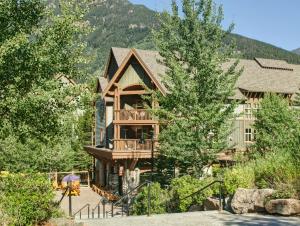a large house with a staircase leading up to it at Panorama Mountain Resort - Ski Tip / Tamarack Condos in Panorama