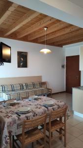 ein Wohnzimmer mit einem Tisch und einem Sofa in der Unterkunft Casa la Celeste in Bibione