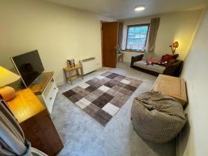 a living room with a couch and a table at Lovely and Spacious 2BD Holiday Retreat Ballater in Ballater