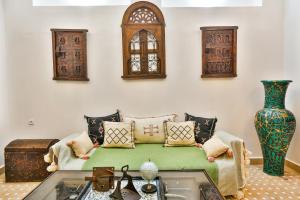 a living room with a couch and a table at Riad Dada Mouss & Suites in Marrakesh