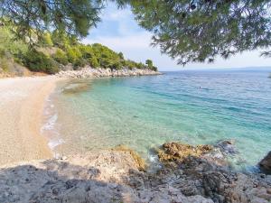 a view of a beach with rocks and the ocean at Villa Majda at the Paradise beach in Murvica