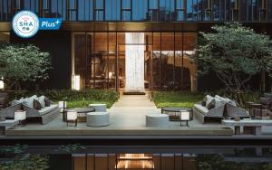 a building with tables and chairs in front of it at Kimpton Maa-Lai Bangkok, an IHG Hotel in Bangkok