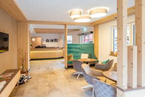 a living room with a table and chairs at Hotel Tiroler Herz in Hinterhornbach