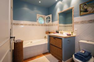 a bathroom with a tub and a sink and a toilet at Domaine du Coussoul in Mouriès +37 photos