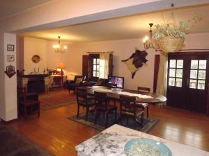 a dining room and living room with a table and chairs at Casa Oliveiras do Douro in Sobreira