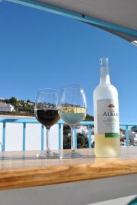 Una botella de vino y dos copas en una mesa. en KiCo en Cómpeta