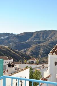 a view from the balcony of a house with mountains in the background at KiCo in Cómpeta