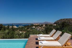 a villa with a pool and a view of the ocean at Eloa Luxury Villa in Chania Town