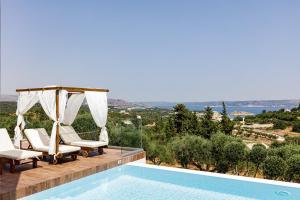 a pool with chairs and a gazebo at Eloa Luxury Villa in Chania Town