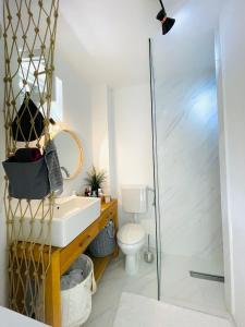 a bathroom with a sink and a shower at Chic sea front apartment with breathtaking Kotor Bay view in Donji Stoliv
