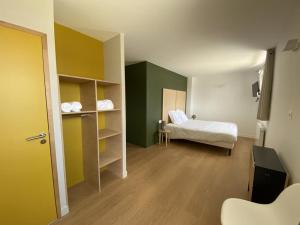 a small room with a bed and a bed and a room with a bed sqor at CHEZ MAMITA in Landivisiau