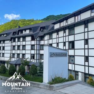 um prédio com uma placa na frente em Fully Equiped, Quiet, for 5 persons, Next To Panoramic Gondola em Brzeće