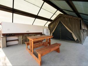 a tent with a bench and a table and a picnic table at Namib Desert Camping2Go in Solitaire