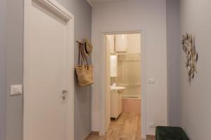 a hallway with a door to a bathroom with a sink at Casa Emy in Rapallo