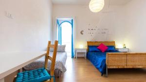 a bedroom with a blue bed and a window at Benvenuti Nel Sud in Sessa Cilento