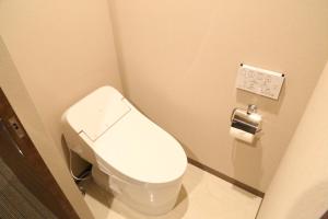 a bathroom with a white toilet in a stall at C＆Jホテル in Tokyo