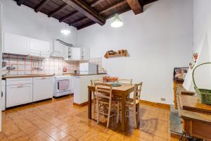 eine Küche mit weißen Geräten und einem Holztisch in der Unterkunft Spanish Steps Spacious Apartment in Rom