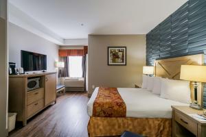 サリーにあるベスト ウエスタン ピース アーチ インのベッドとテレビが備わるホテルルームです。