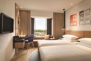 JEN Singapore Tanglin by Shangri-La客房内的一张或多张床位