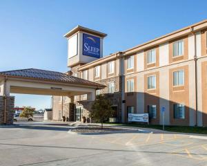 a hotel building with a sign on top of it at Sleep Inn & Suites Norton in Norton