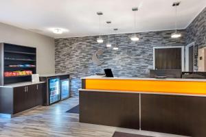 an office lobby with a counter and a bar at Comfort Inn & Suites in Emporia