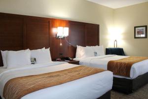a hotel room with two beds in a room at Comfort Inn & Suites in Fultondale