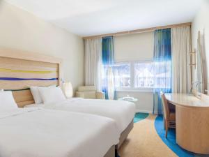 Voodi või voodid majutusasutuse Radisson Blu Airport Terminal Hotel toas