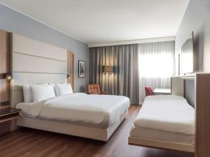 Voodi või voodid majutusasutuse Radisson Blu Airport Terminal Hotel toas