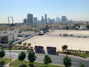 a large parking lot with a city in the background at Baity Hotel Apartments in Dubai