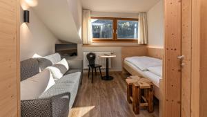 a small room with two beds and a window at Garni Pramstrahler in Chiusa