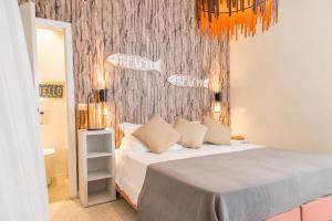 a bedroom with a bed and a wall with fishes at Hotel Rex in Gabicce Mare