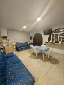 a living room with a blue couch and a table at LAS 7 ISLAS, BARRANCO DE ADEJE in Adeje