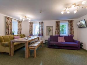 a living room with a couch and a table at Alpenresidenz Fieberbrunn in Fieberbrunn