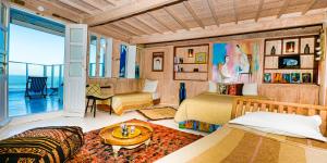a bedroom with two beds and a view of the ocean at Dar Cherazade & spa in Essaouira