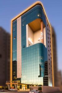a tall building with a lot of glass windows at Al Malqa Elite Hotel in Riyadh