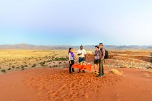 a group of people standing in the desert at Namib Desert Camping2Go in Solitaire +5 photos